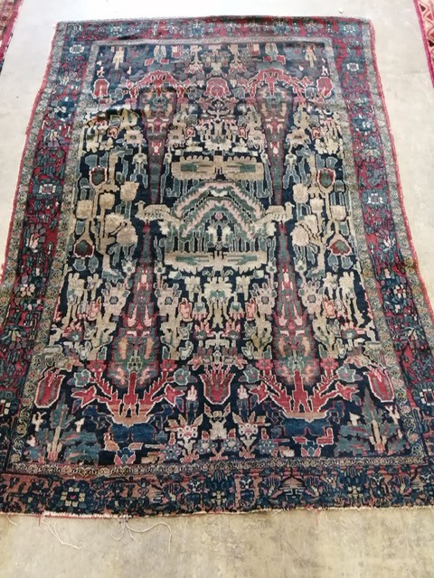 An antique Persian blue ground rug, woven with birds within a garden, 170 x 120cm